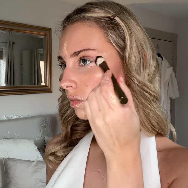 Model applying concealer with Brush No. 02 vegan brush for smooth, natural coverage under the eyes.